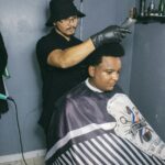 Hairdresser gives a precise haircut to a customer in Breves, Brazil salon.