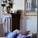 Inviting bedroom interior featuring pink bedspread and blue pillows.